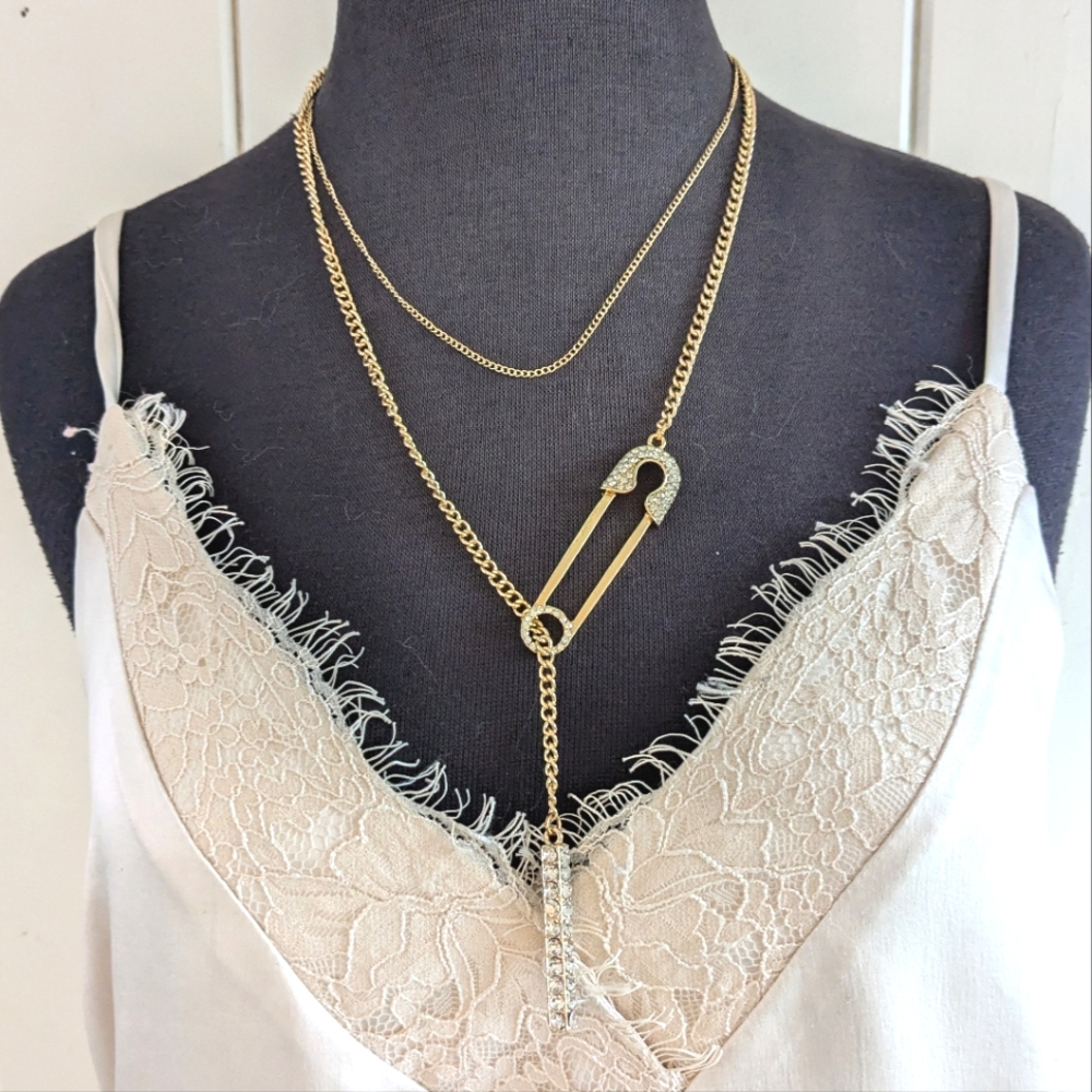Gold and Crystal Layered Necklaces with Intricate Charm